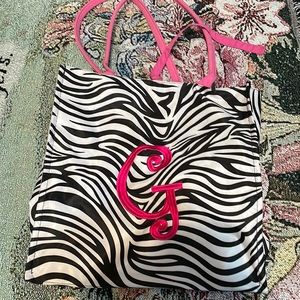 Zebra striped bag with a pink G